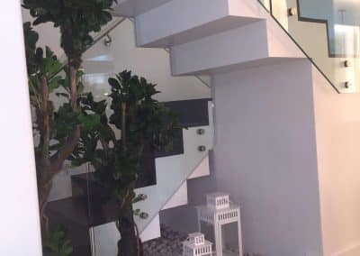 Escaleras de madera y barandilla de vidrio flotante Miguel Residence